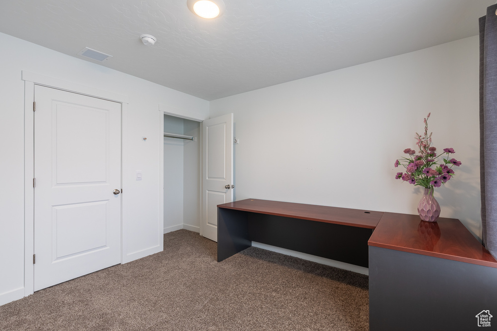 Unfurnished office featuring carpet flooring