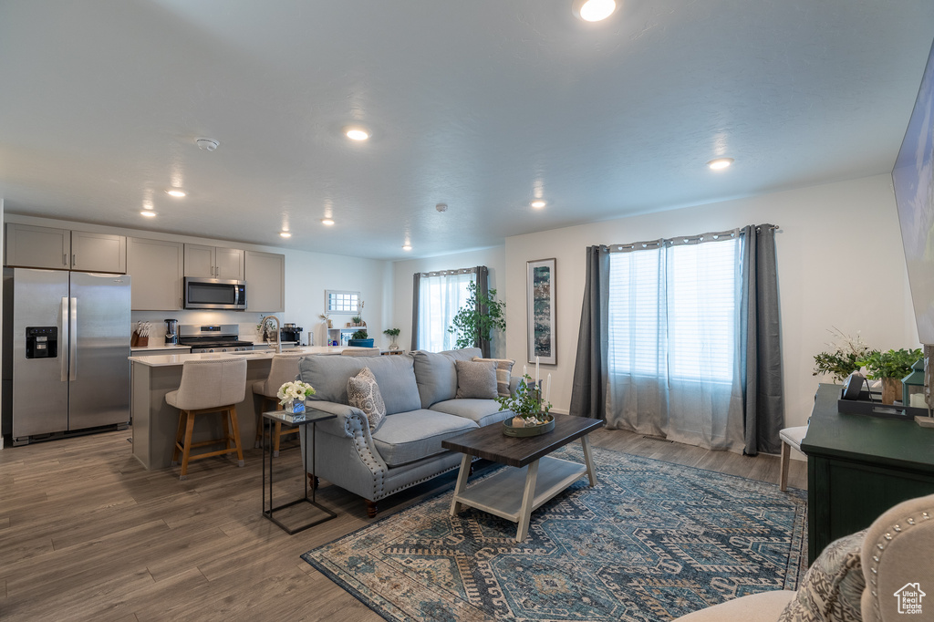 Living room featuring wood finished floors and recessed lighting