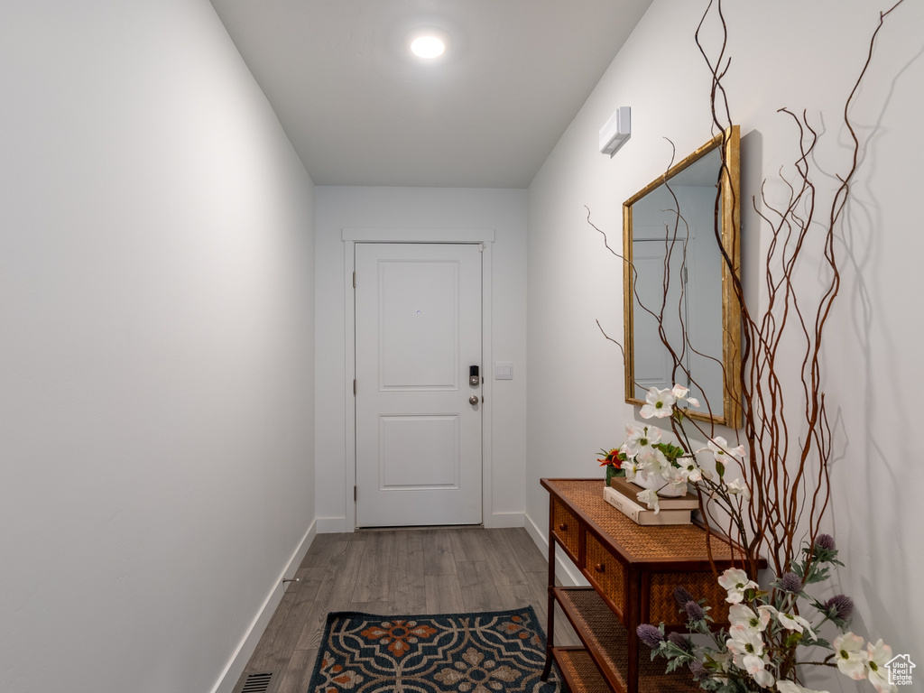 Entryway with wood finished floors and baseboards