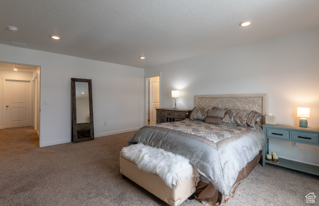 Carpeted bedroom featuring recessed lighting and baseboards