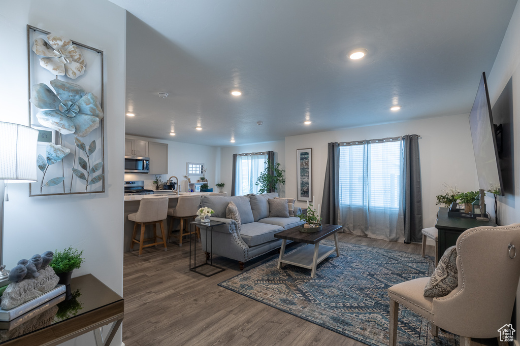 Living area with wood finished floors and recessed lighting