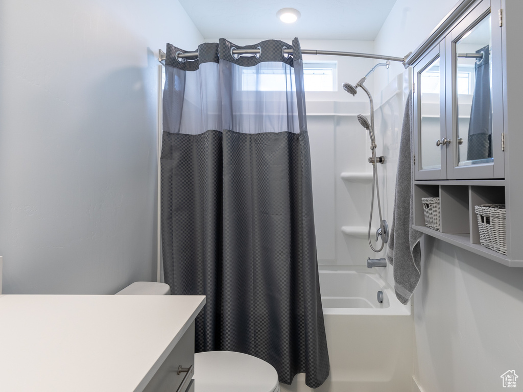 Full bath featuring shower / bath combo, vanity, and toilet