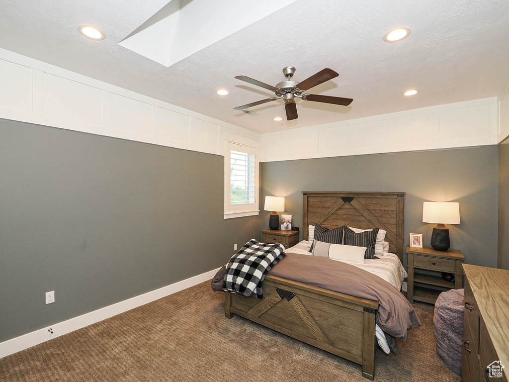 Bedroom featuring carpet flooring, recessed lighting, a skylight, ceiling fan, and baseboards