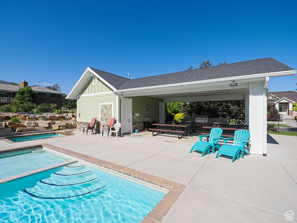 View of pool featuring a patio area and a jacuzzi