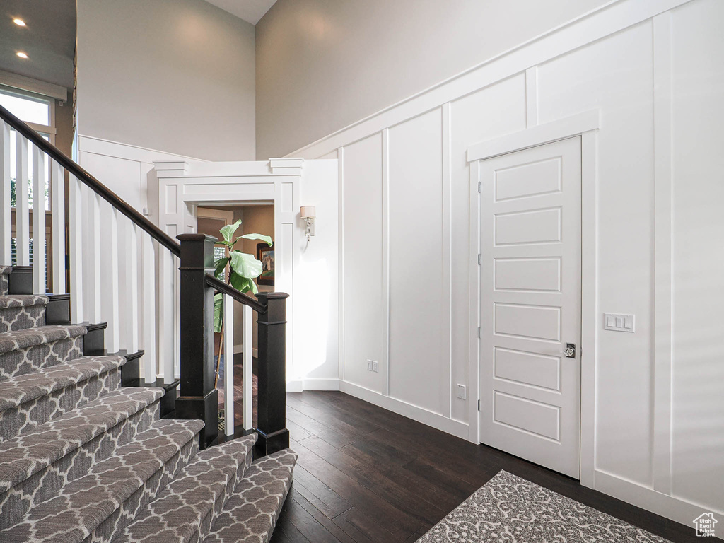 Entrance foyer featuring stairway, dark wood finished floors, and recessed lighting