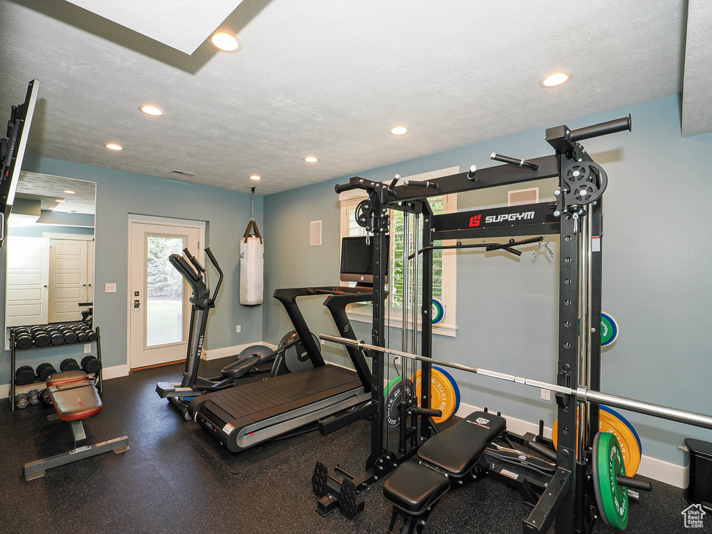 Exercise room with recessed lighting and baseboards