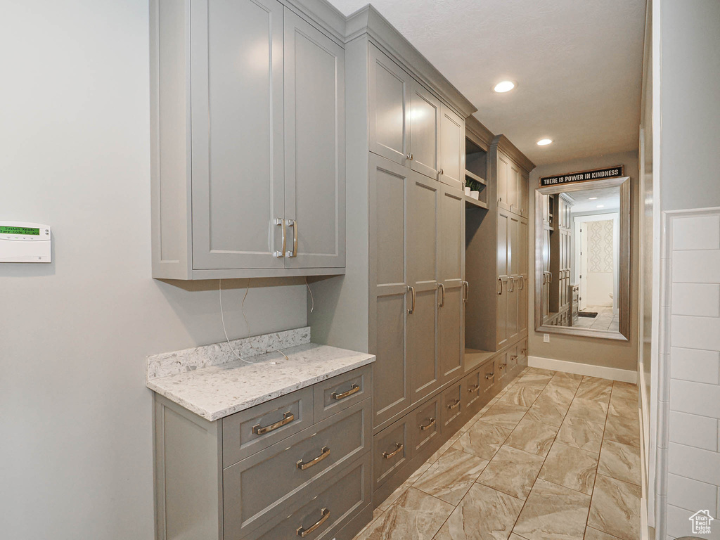 Mudroom featuring light marble finish floors and recessed lighting