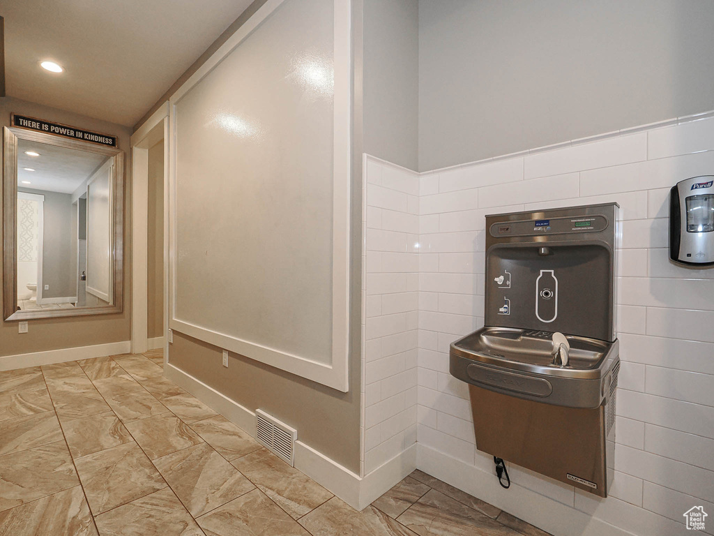 Detailed view of baseboards and recessed lighting
