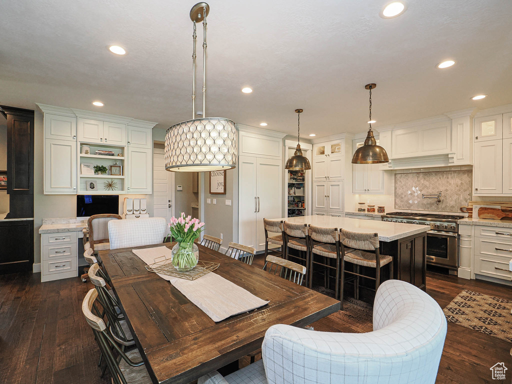 Dining space featuring recessed lighting and dark wood-style flooring