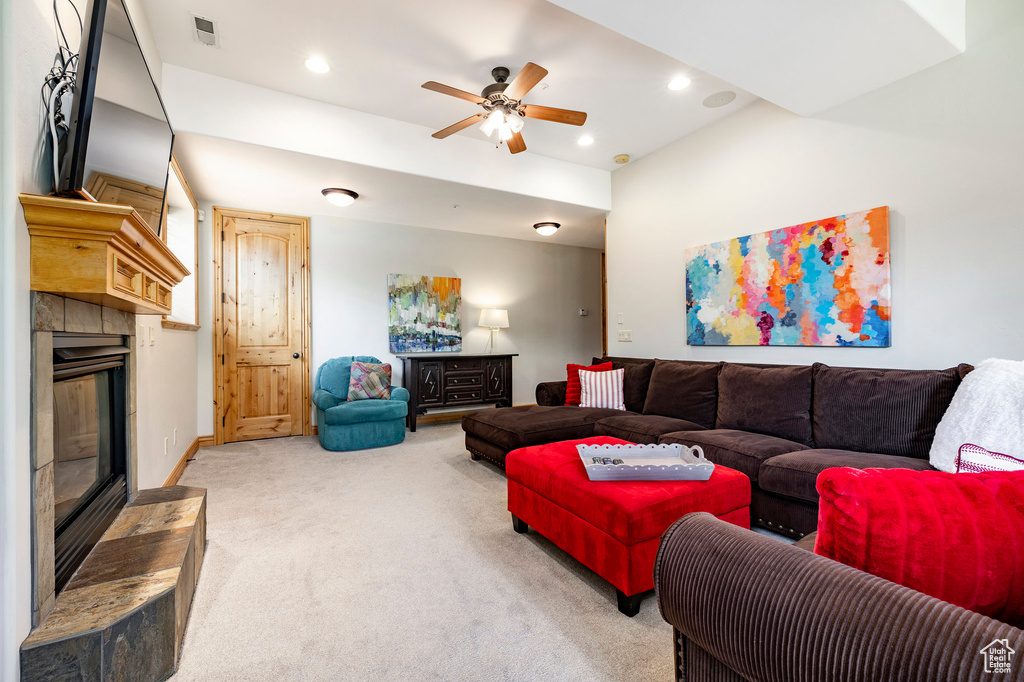 Living room featuring carpet floors, a glass covered fireplace, a ceiling fan, and recessed lighting