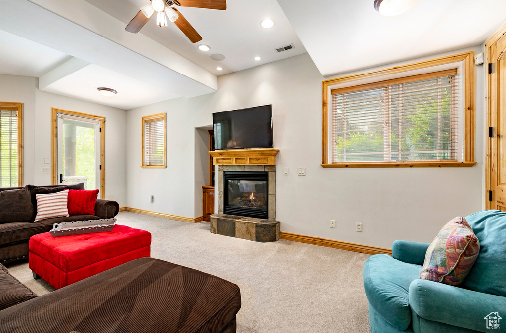 Living room with light carpet, baseboards, a tile fireplace, healthy amount of natural light, and recessed lighting