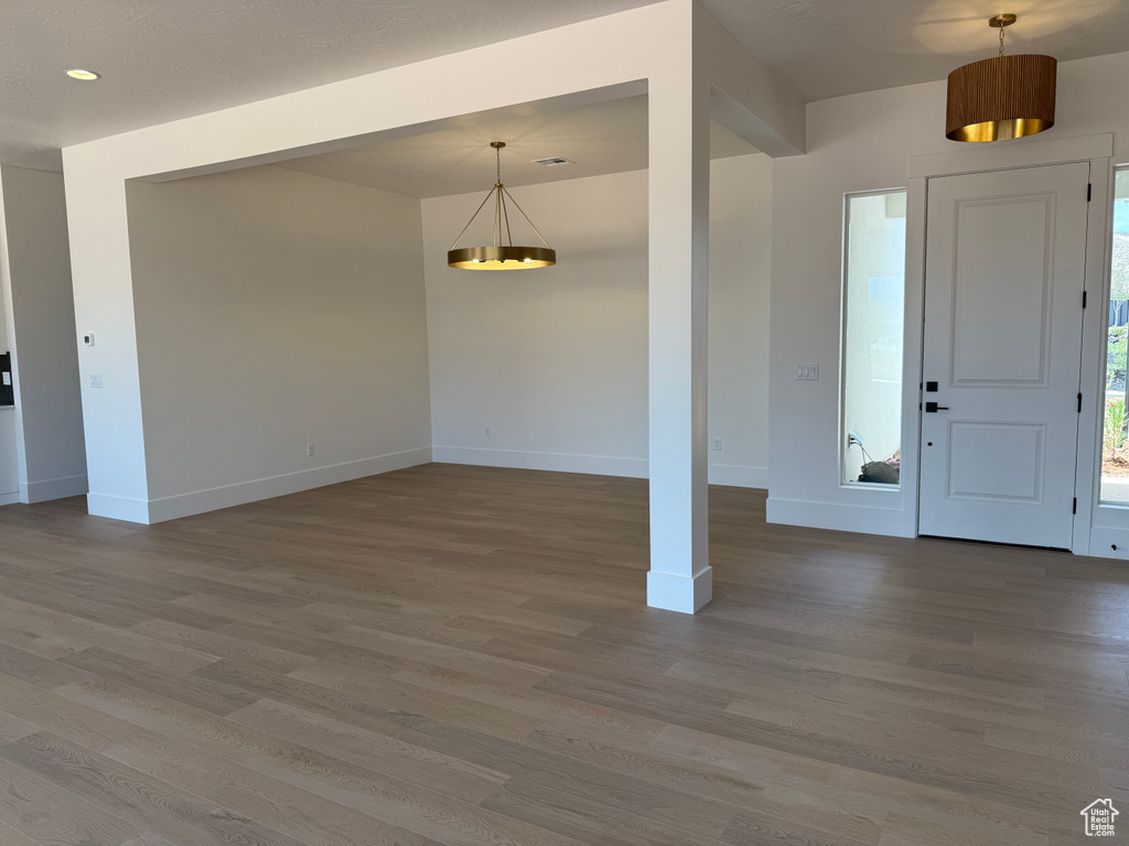 Entrance foyer featuring a chandelier, wood finished floors, and recessed lighting