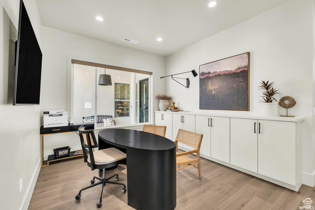 Home office featuring light wood-style floors, recessed lighting, and baseboards