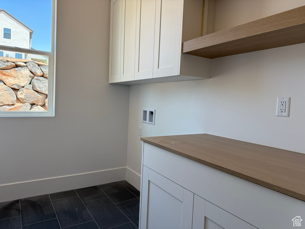 Washroom with cabinet space and washer hookup