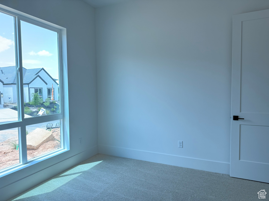 Carpeted spare room with plenty of natural light