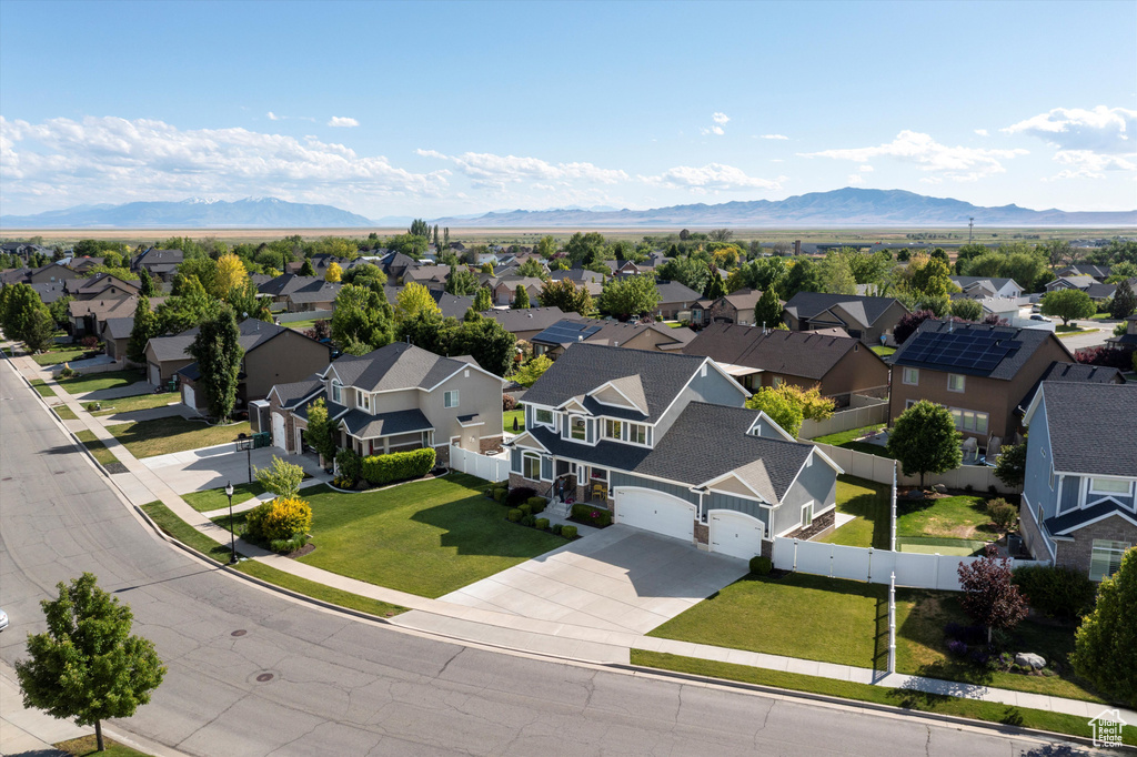 Aerial perspective of suburban area featuring a mountainous background
