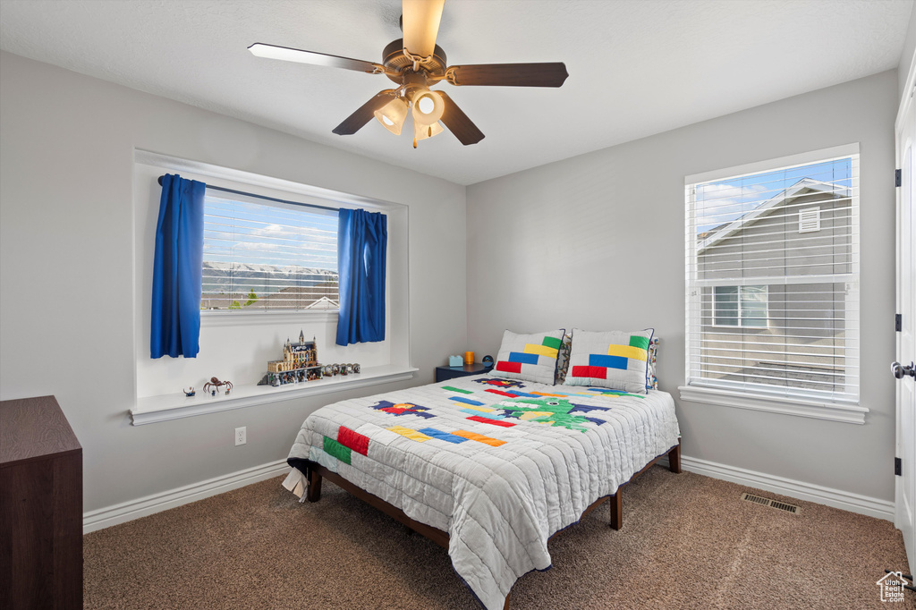 Bedroom with carpet, baseboards, and ceiling fan