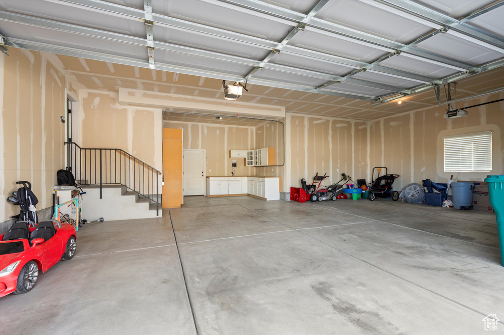 Garage featuring a garage door opener