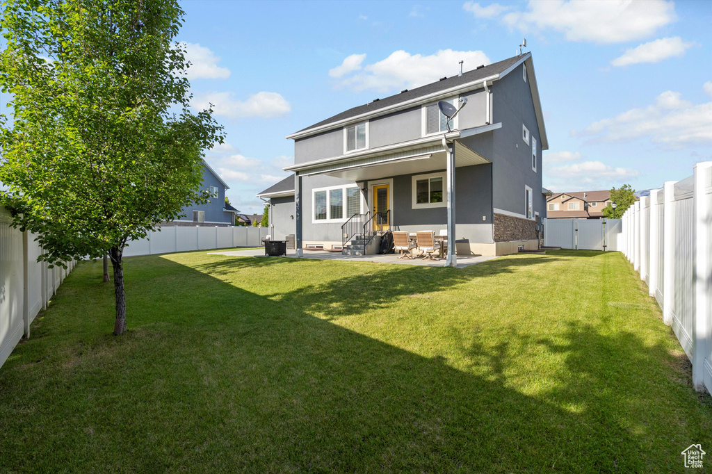 Back of property featuring entry steps, stucco siding, and a patio