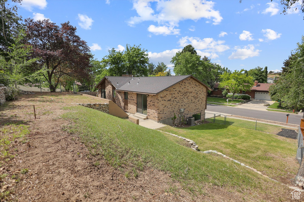 View of home\'s exterior featuring brick siding and central AC unit