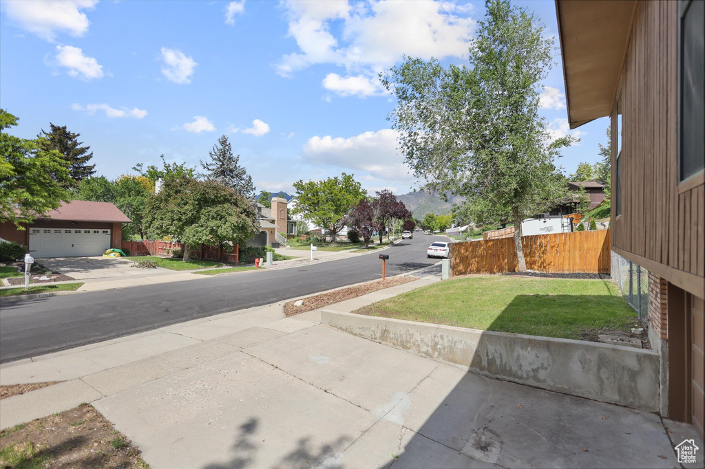 View of asphalt street with sidewalks and a residential view
