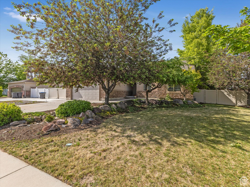 View of yard featuring driveway and an attached garage