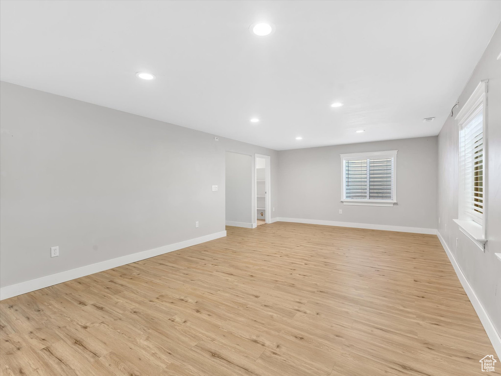 Empty room featuring light wood-style flooring, recessed lighting, and baseboards