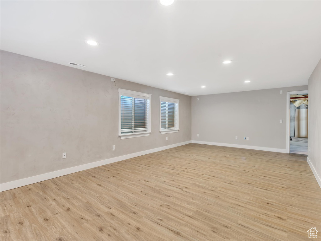 Empty room with light wood-type flooring, recessed lighting, and baseboards