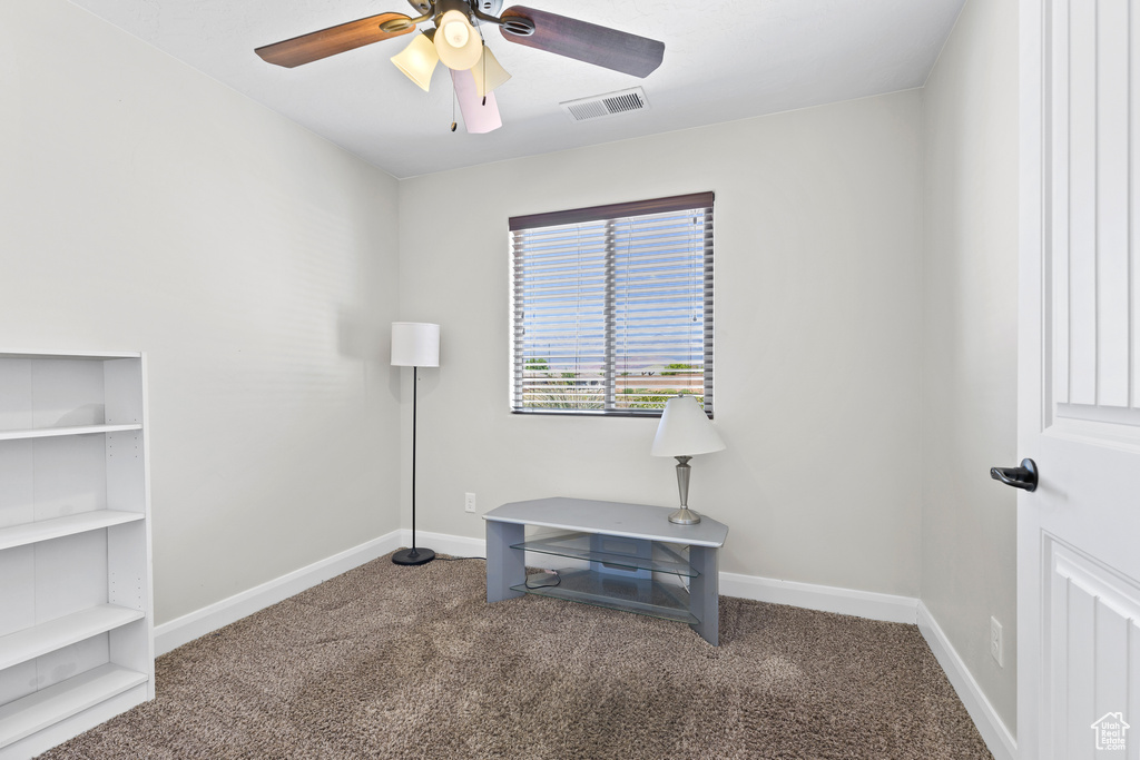 Unfurnished office featuring carpet floors, ceiling fan, baseboards, and built in features