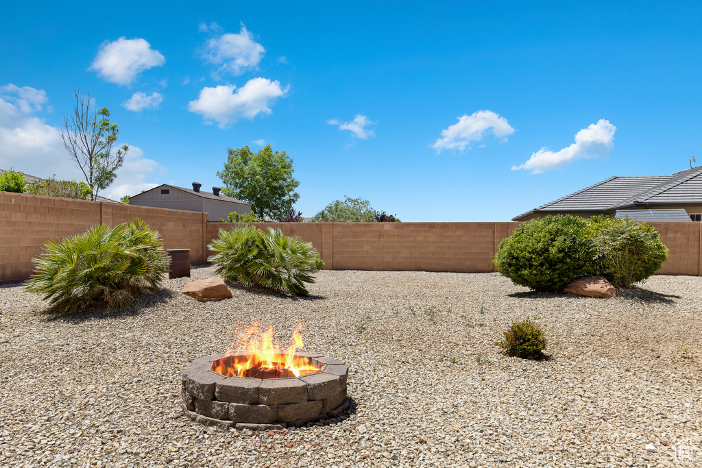 Fenced backyard with an outdoor fire pit