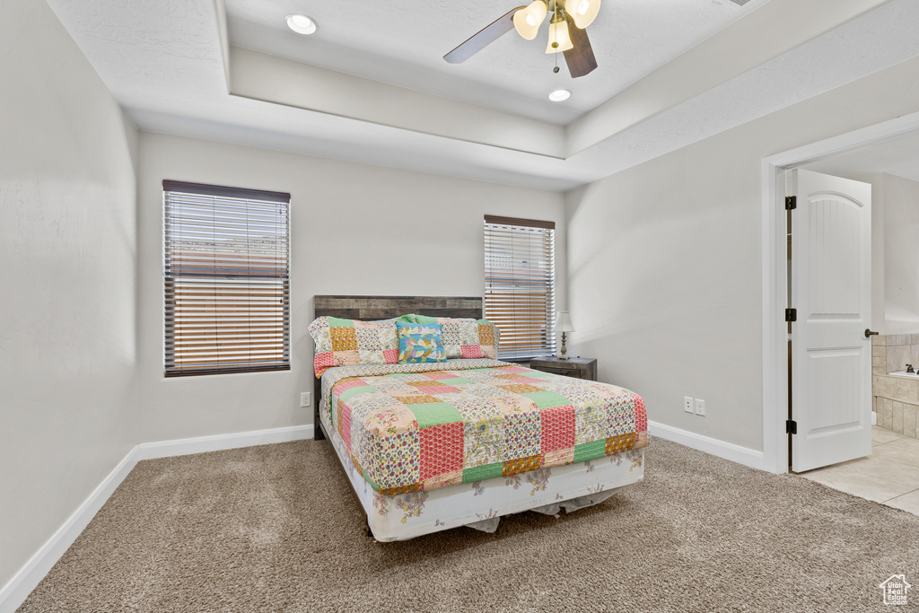 Bedroom with carpet flooring, multiple windows, and baseboards