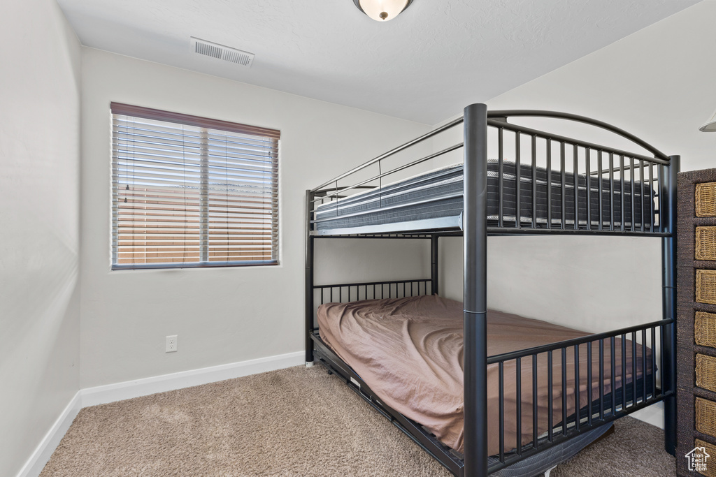 Bedroom with carpet and baseboards