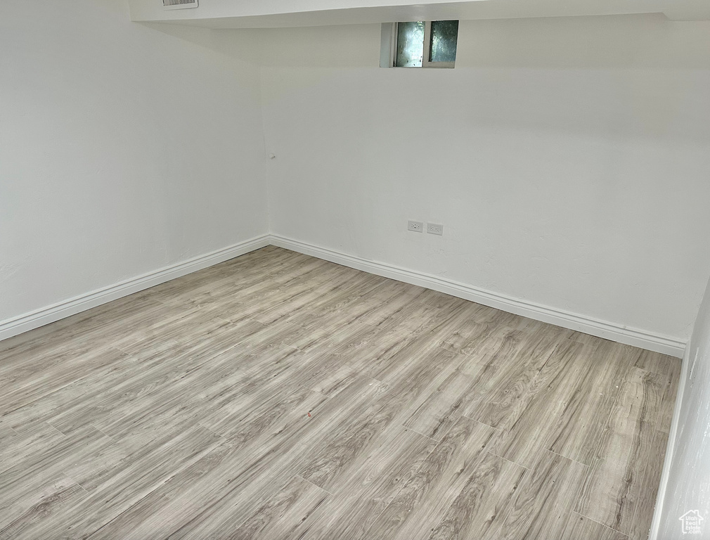 Finished below grade area featuring wood finished floors and baseboards