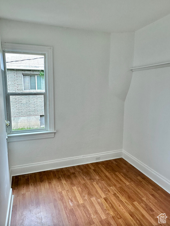 Spare room featuring wood finished floors and baseboards