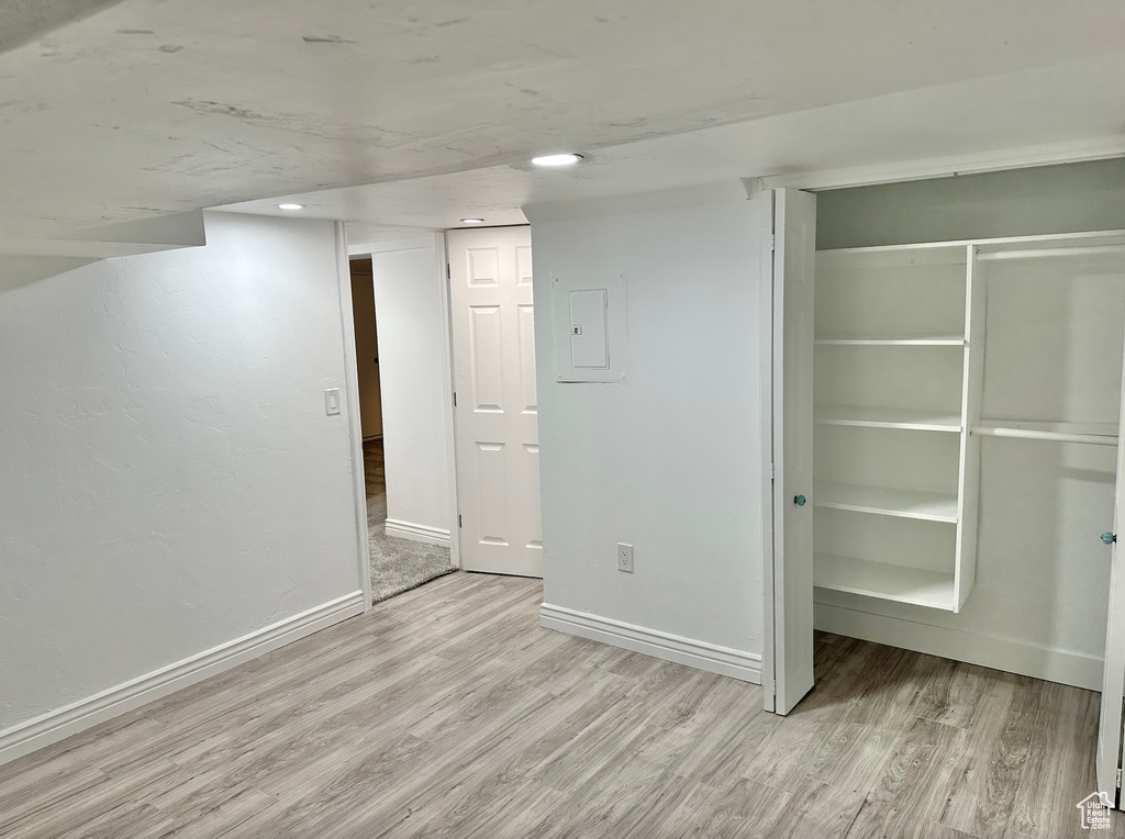 Finished below grade area featuring wood finished floors and baseboards