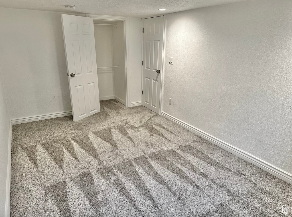 Unfurnished bedroom with carpet, baseboards, and a closet