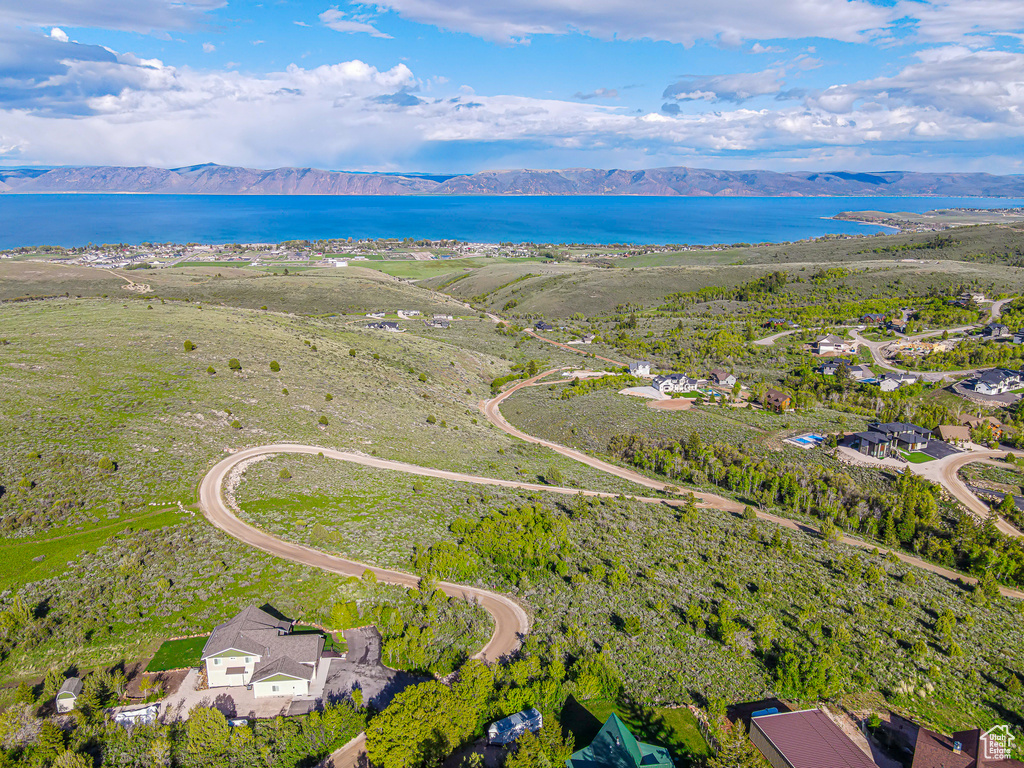 Aerial view of property's location featuring a water and mountain view