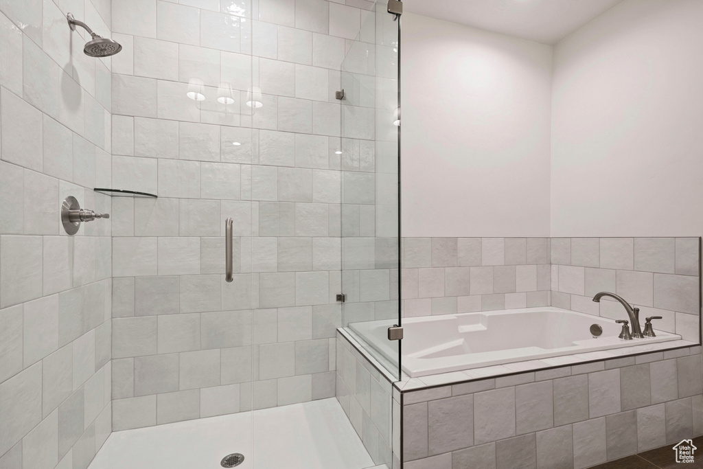Bathroom featuring a shower stall and a garden tub