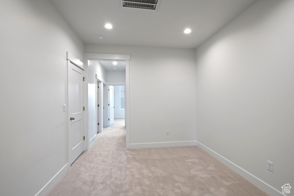 Spare room with light carpet, recessed lighting, and baseboards