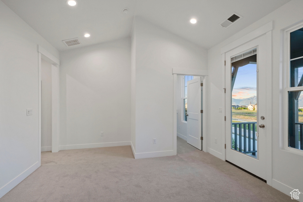 Carpeted spare room with recessed lighting, baseboards, and lofted ceiling