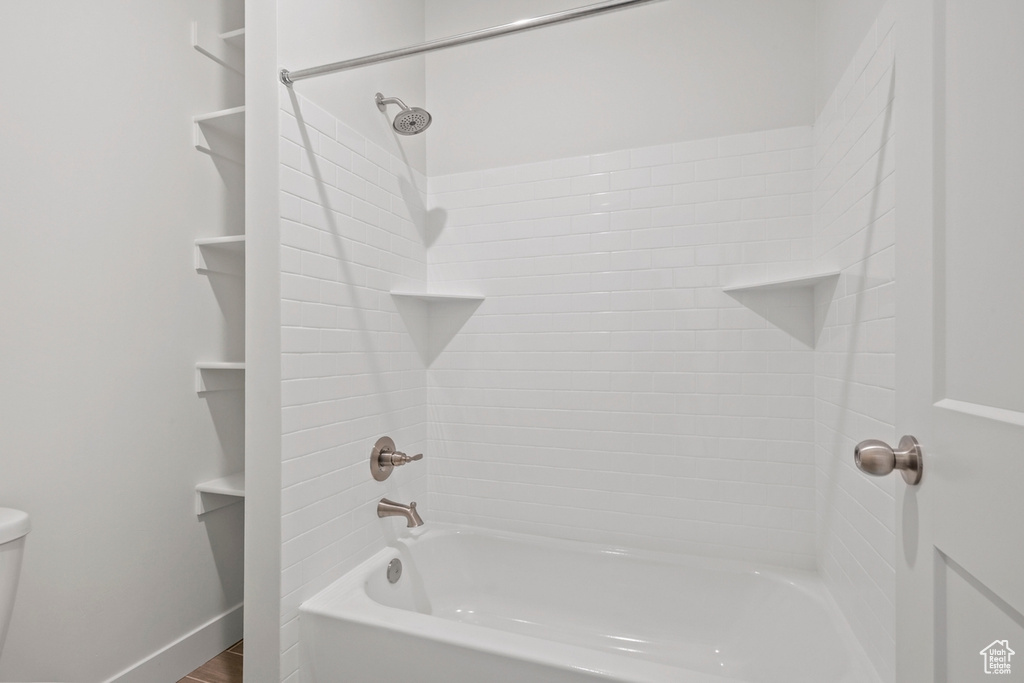 Full bath featuring tub / shower combination and toilet