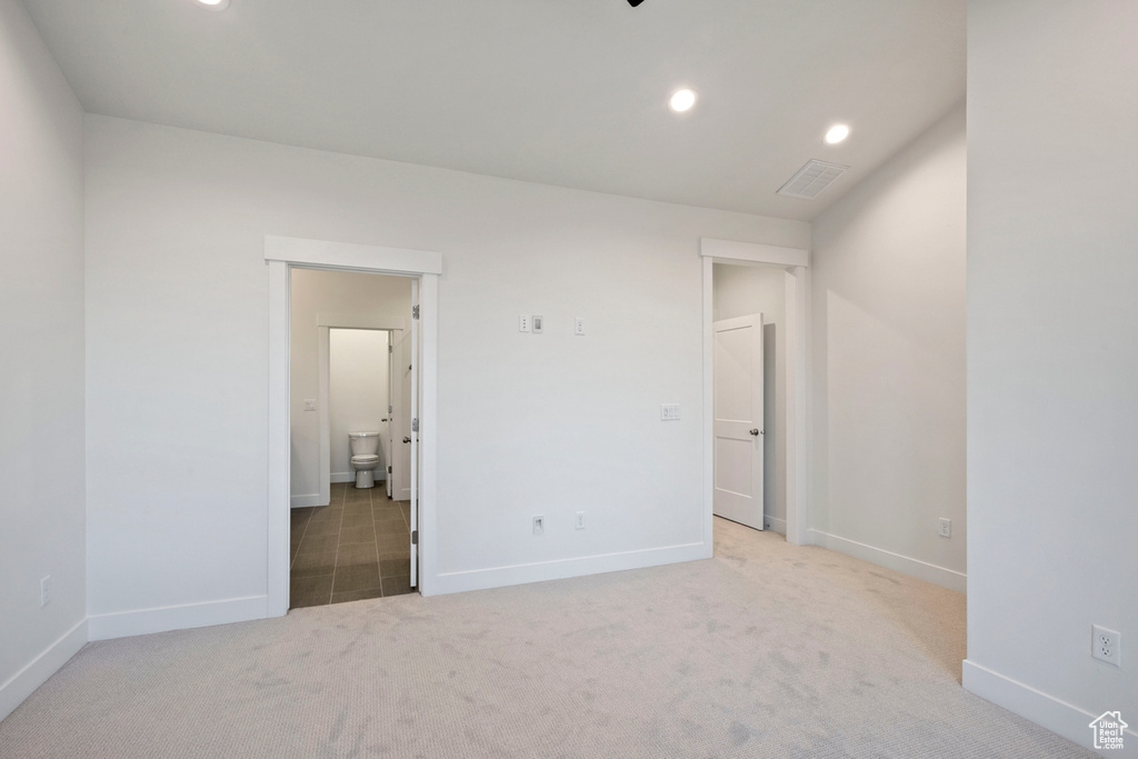 Unfurnished room featuring carpet floors, baseboards, and recessed lighting