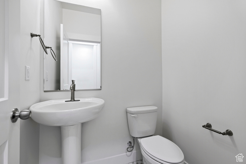 Bathroom featuring toilet and baseboards