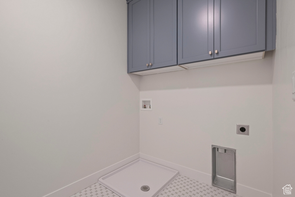 Laundry area with cabinet space, hookup for a washing machine, hookup for an electric dryer, and baseboards