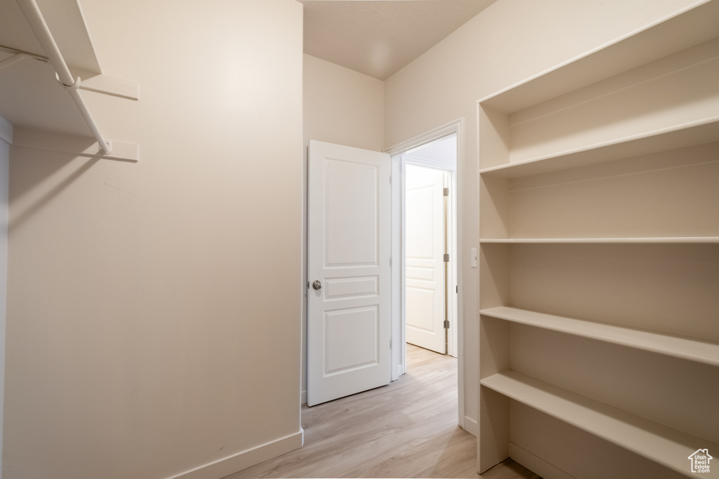 Spacious closet with light wood-style flooring