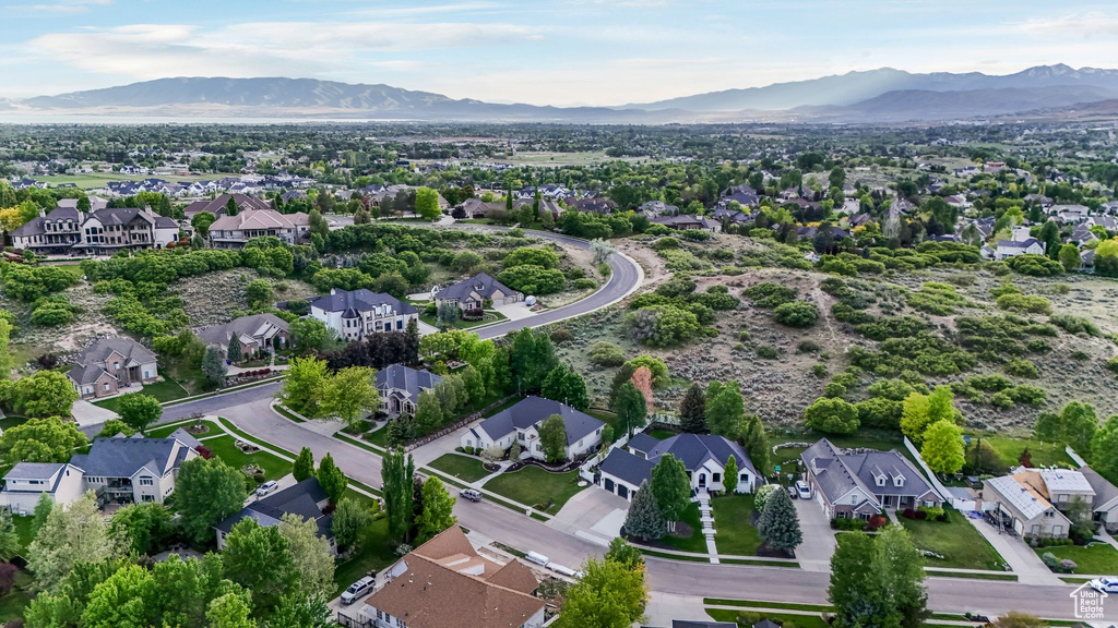 Aerial overview of property's location featuring a mountain backdrop and nearby suburban area