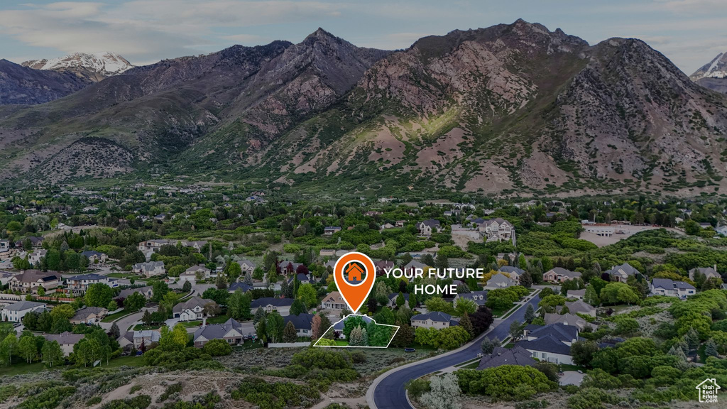 Aerial view of property and surrounding area with a mountain backdrop