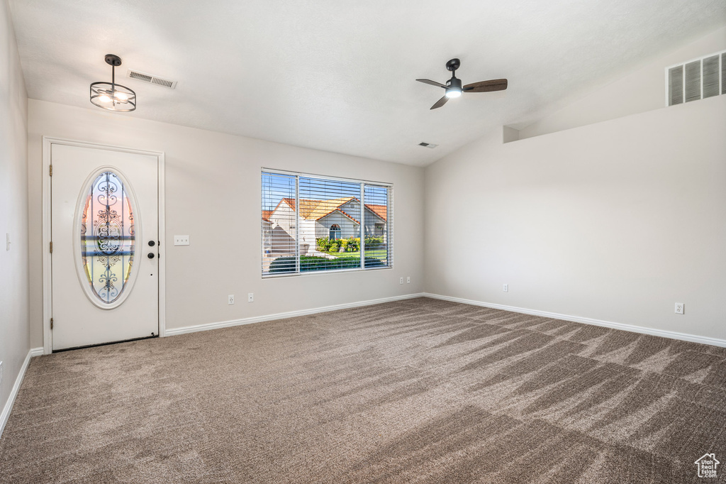 Entryway with carpet floors, a ceiling fan, lofted ceiling, and baseboards