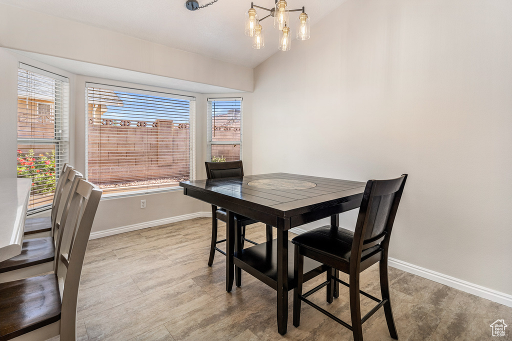 Dining room with plenty of natural light, baseboards, and lofted ceiling