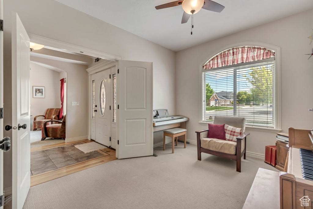 Entrance foyer featuring ceiling fan and baseboards